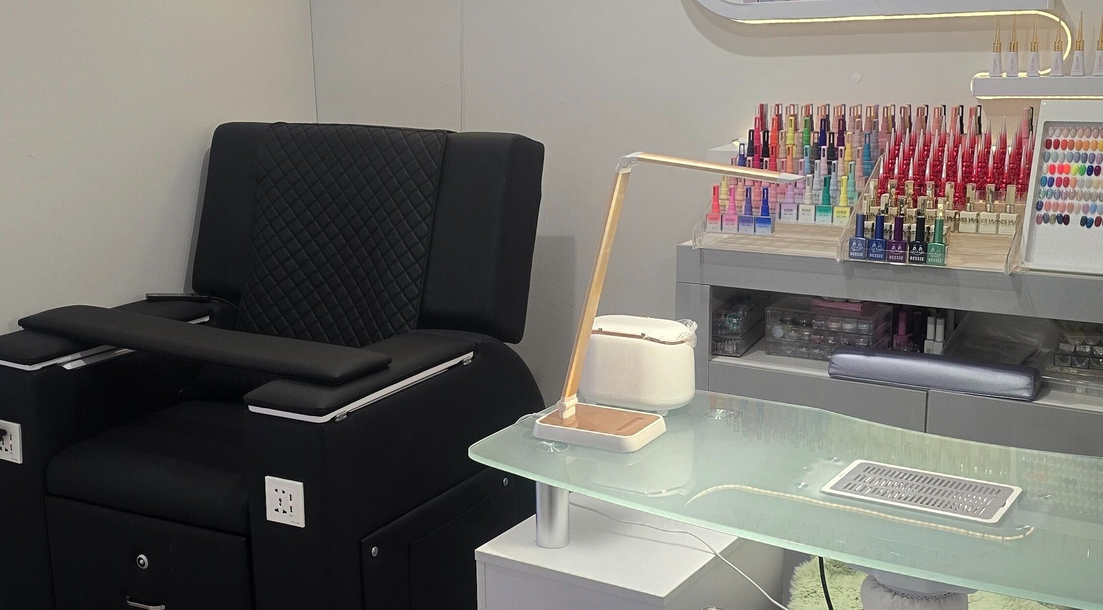 Modern nail station at Bella's Beauty, Christchurch, Canterbury Region, NZ, featuring colorful polish display.