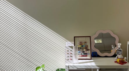 Nail color display on a table with a mirror at Onyu Nail Studio, Sydney, New South Wales, AU.