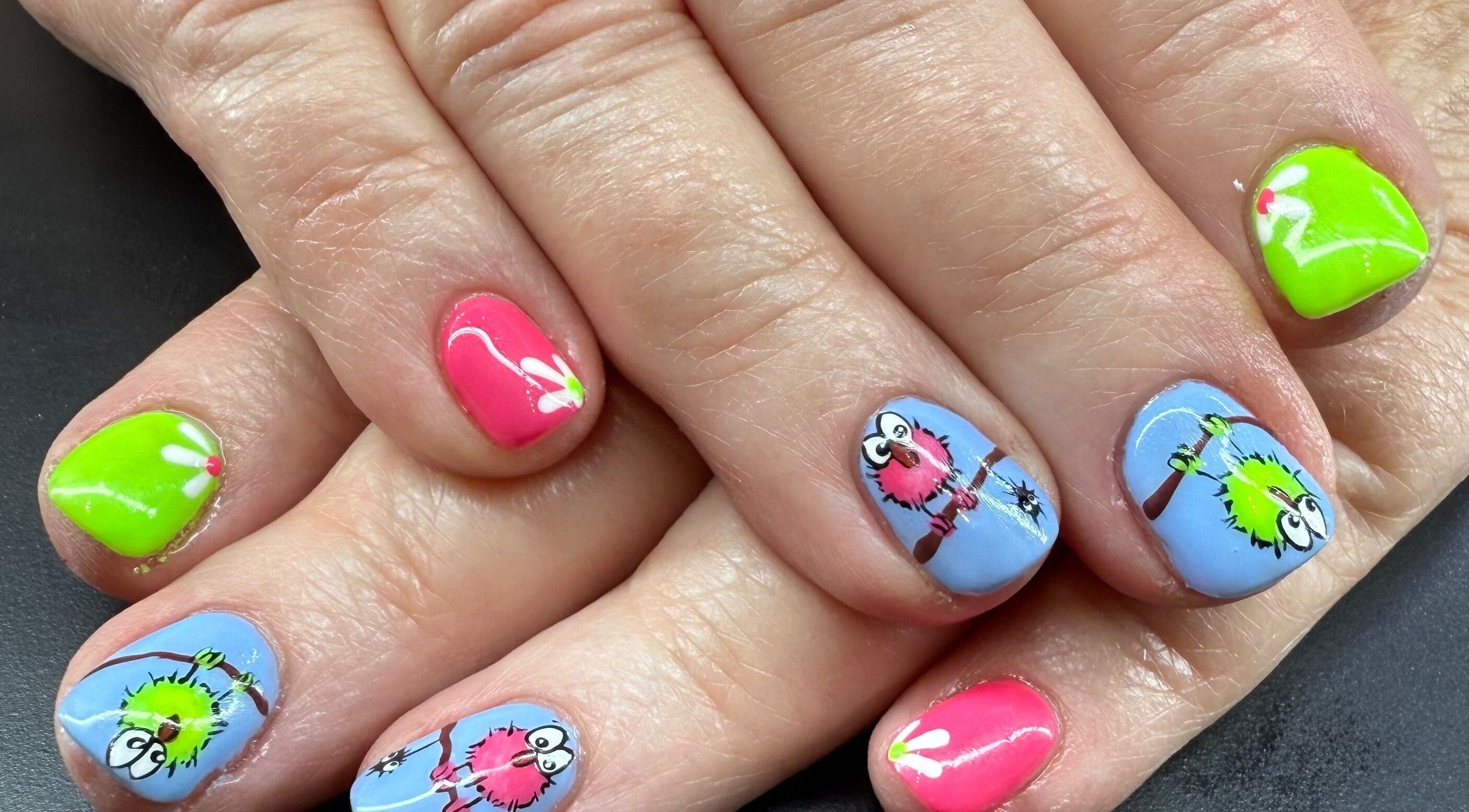 Colorful owl nail art at Glam By Leigh, Washington, Utah, US. Features vibrant pink and green designs.
