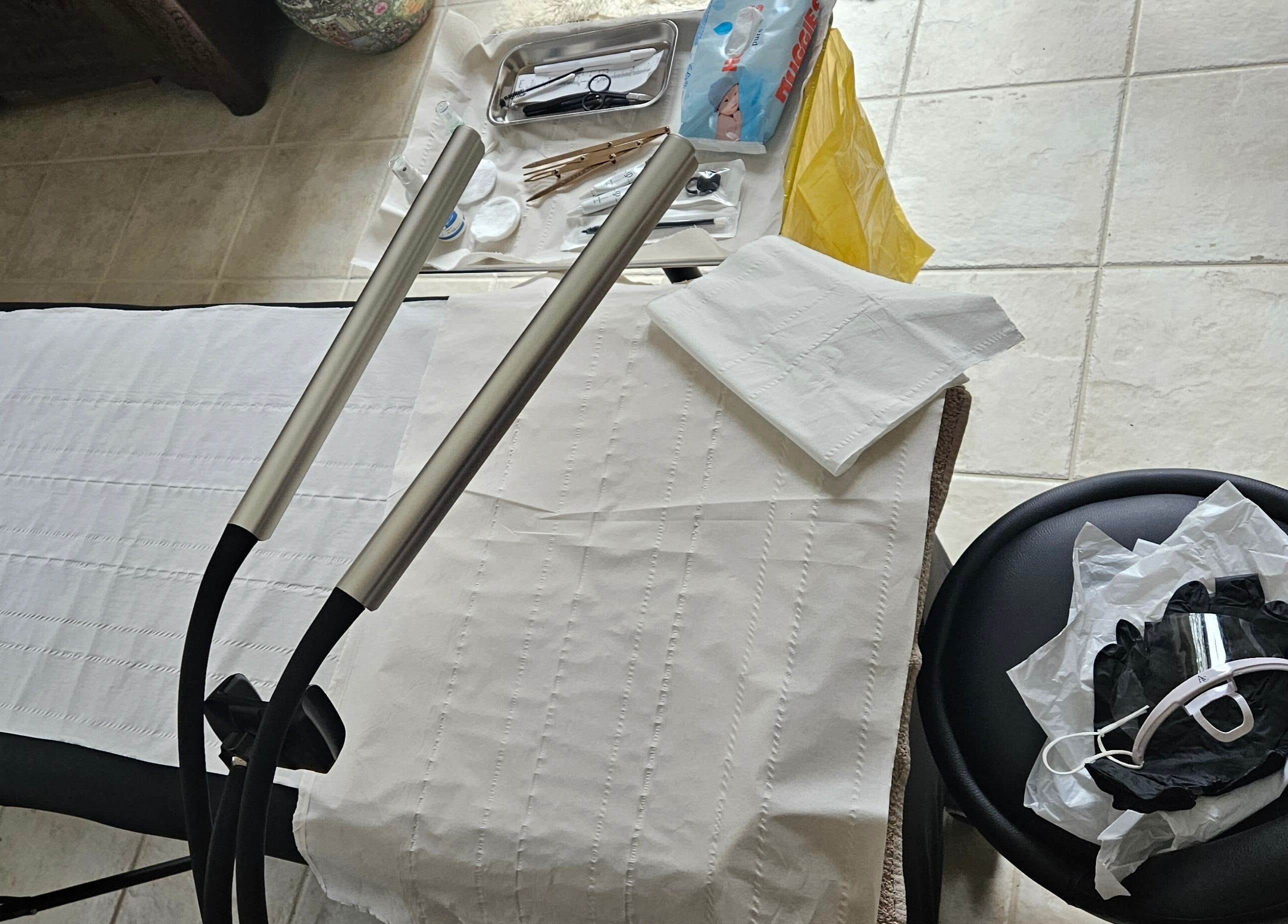 Treatment area at ELM Skin & Brows in Llantwit Major, Wales, GB showing tools and a massage bed.