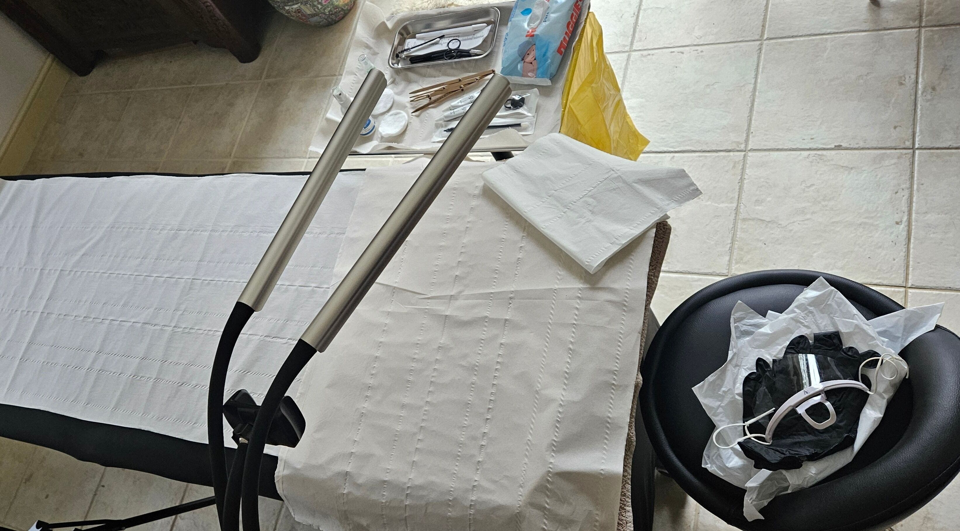 Treatment area at ELM Skin & Brows in Llantwit Major, Wales, GB showing tools and a massage bed.