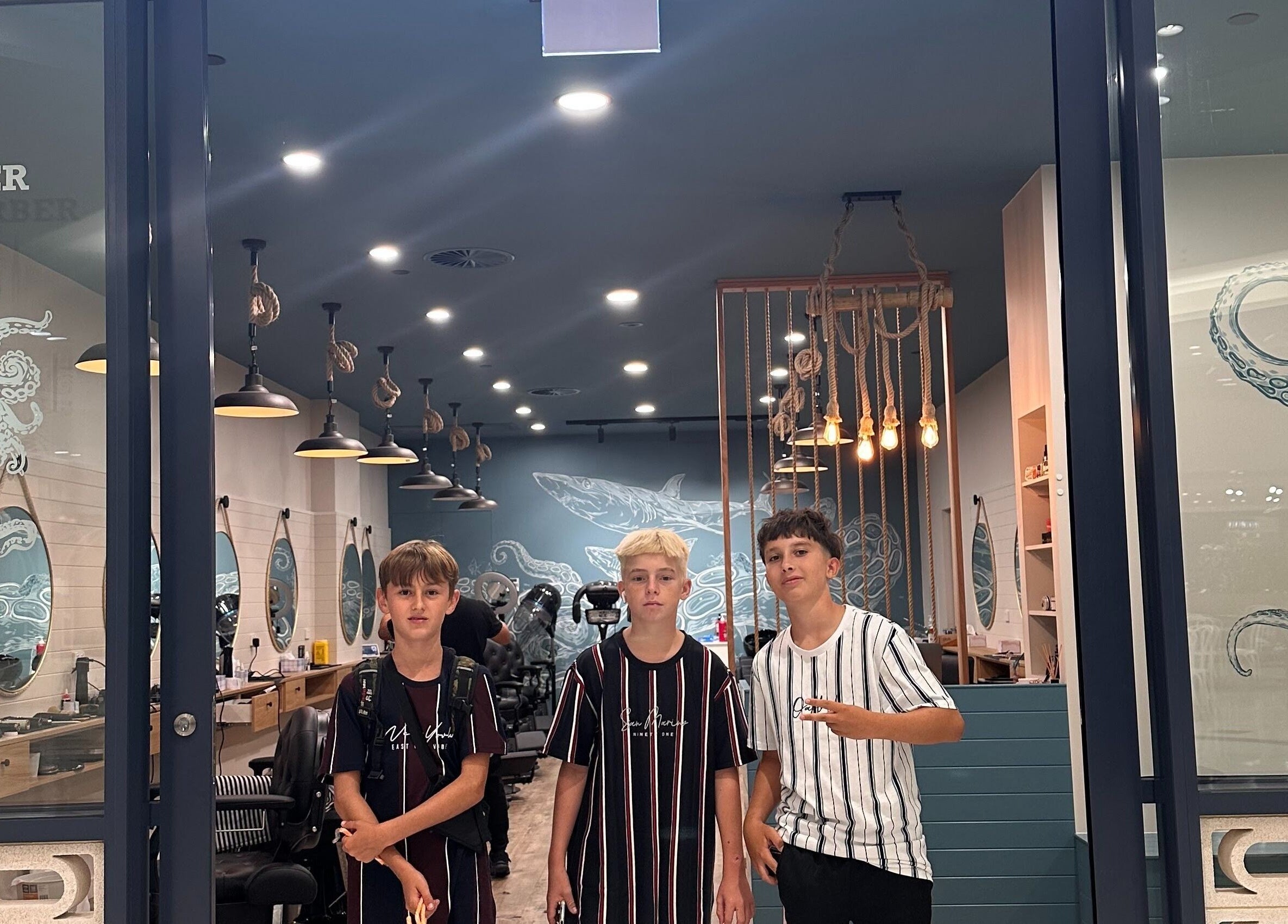 Inside view of Captain Barber - Whitford, Hillarys, showcasing stylish interior with young customers, Western Australia.