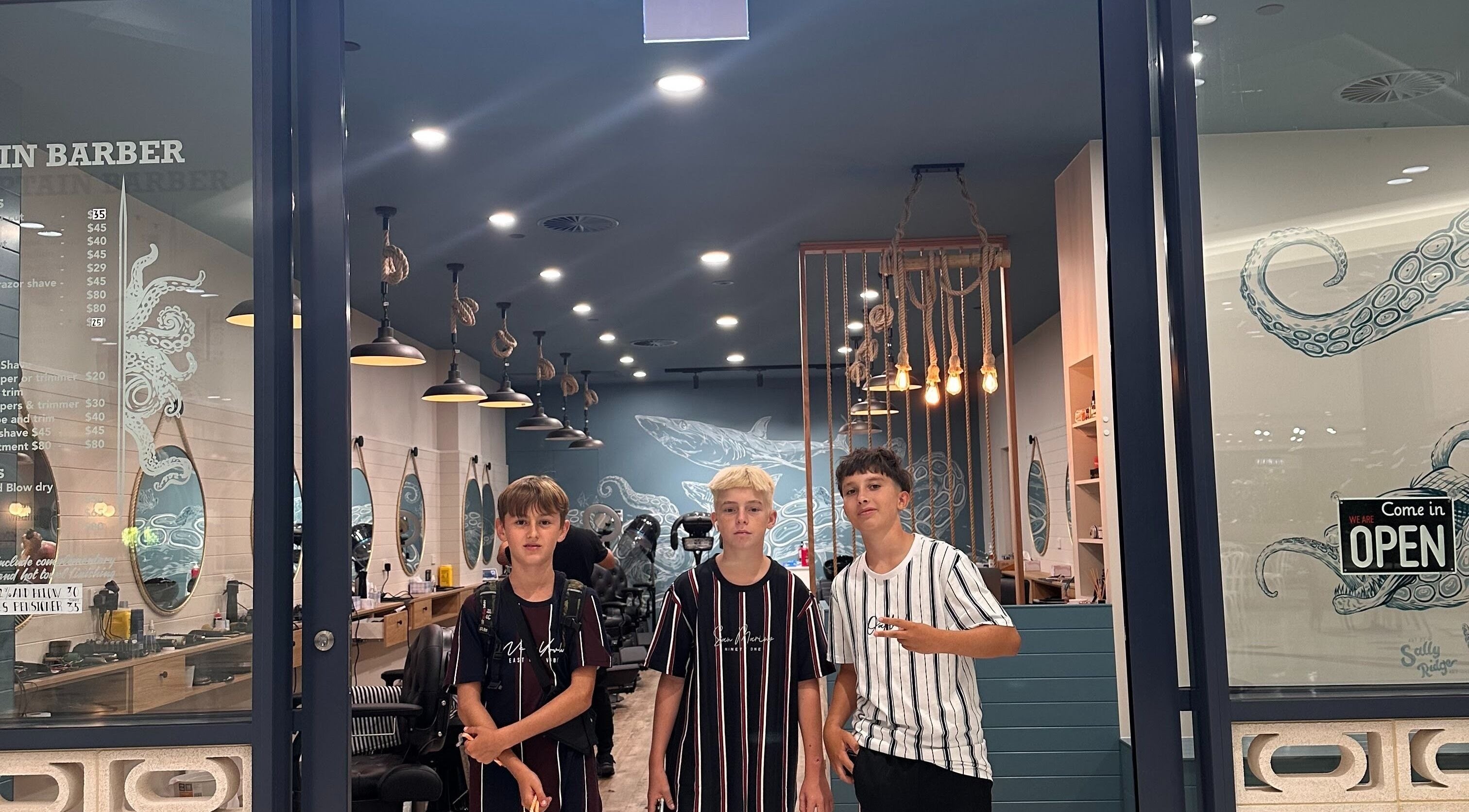 Inside view of Captain Barber - Whitford, Hillarys, showcasing stylish interior with young customers, Western Australia.