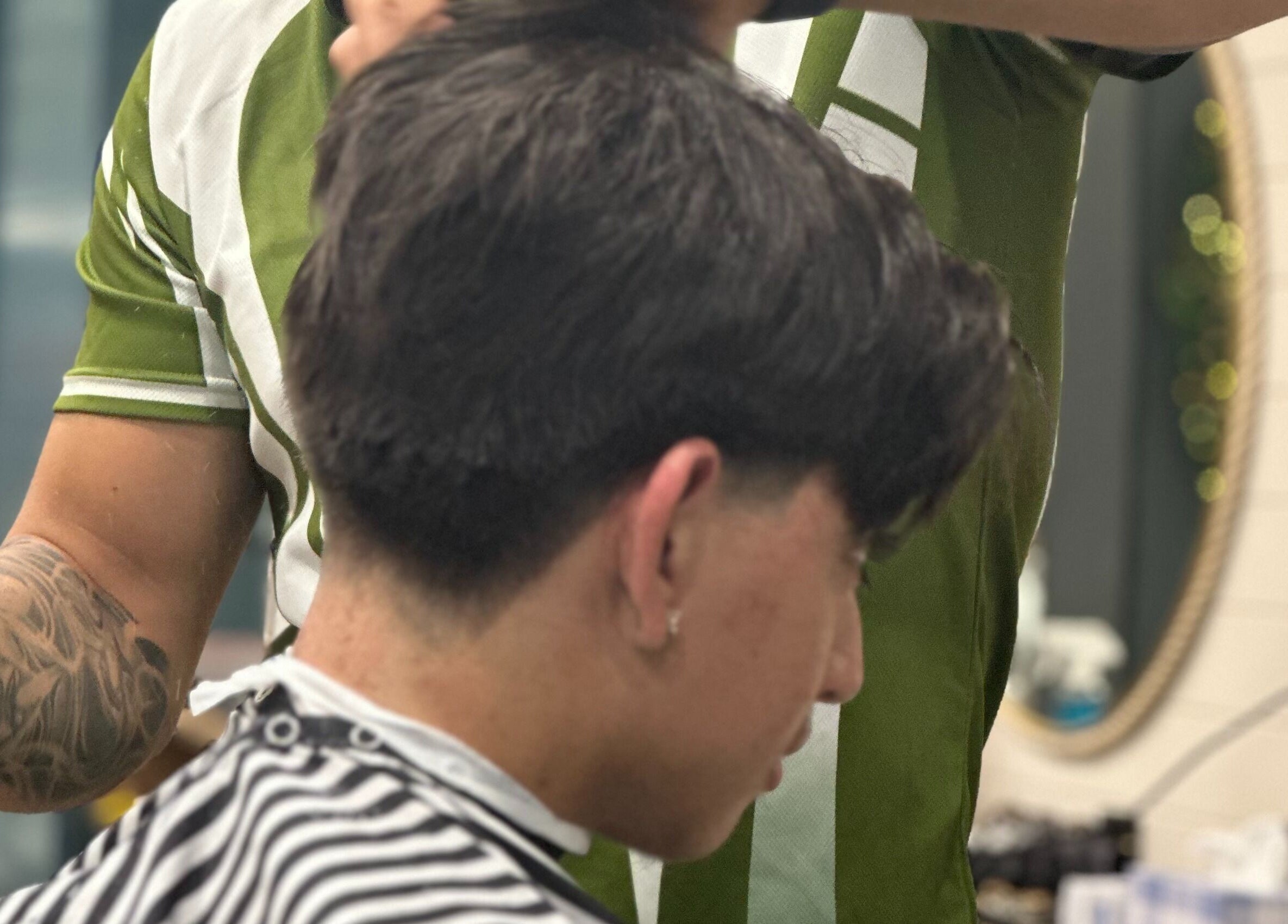 Barber styling hair at Captain Barber - Whitford, Hillarys, Western Australia, AU, using premium products.