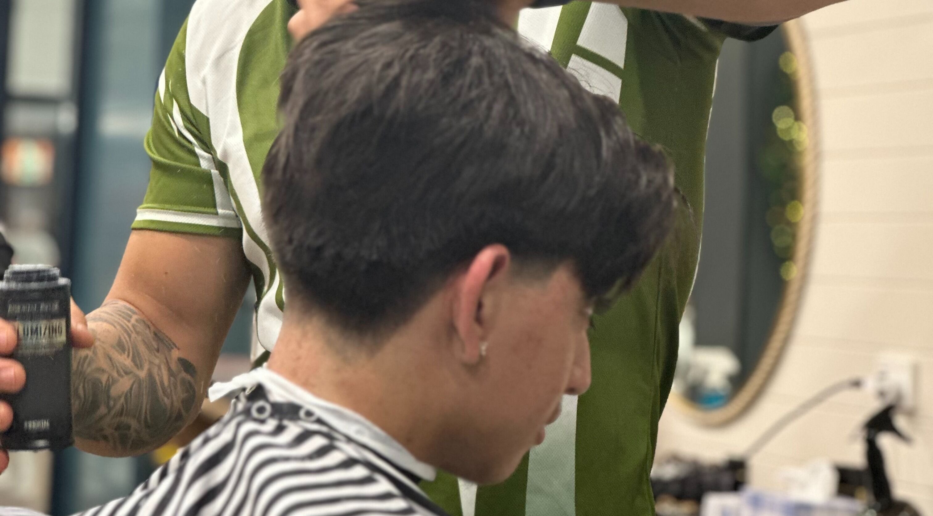 Barber styling hair at Captain Barber - Whitford, Hillarys, Western Australia, AU, using premium products.