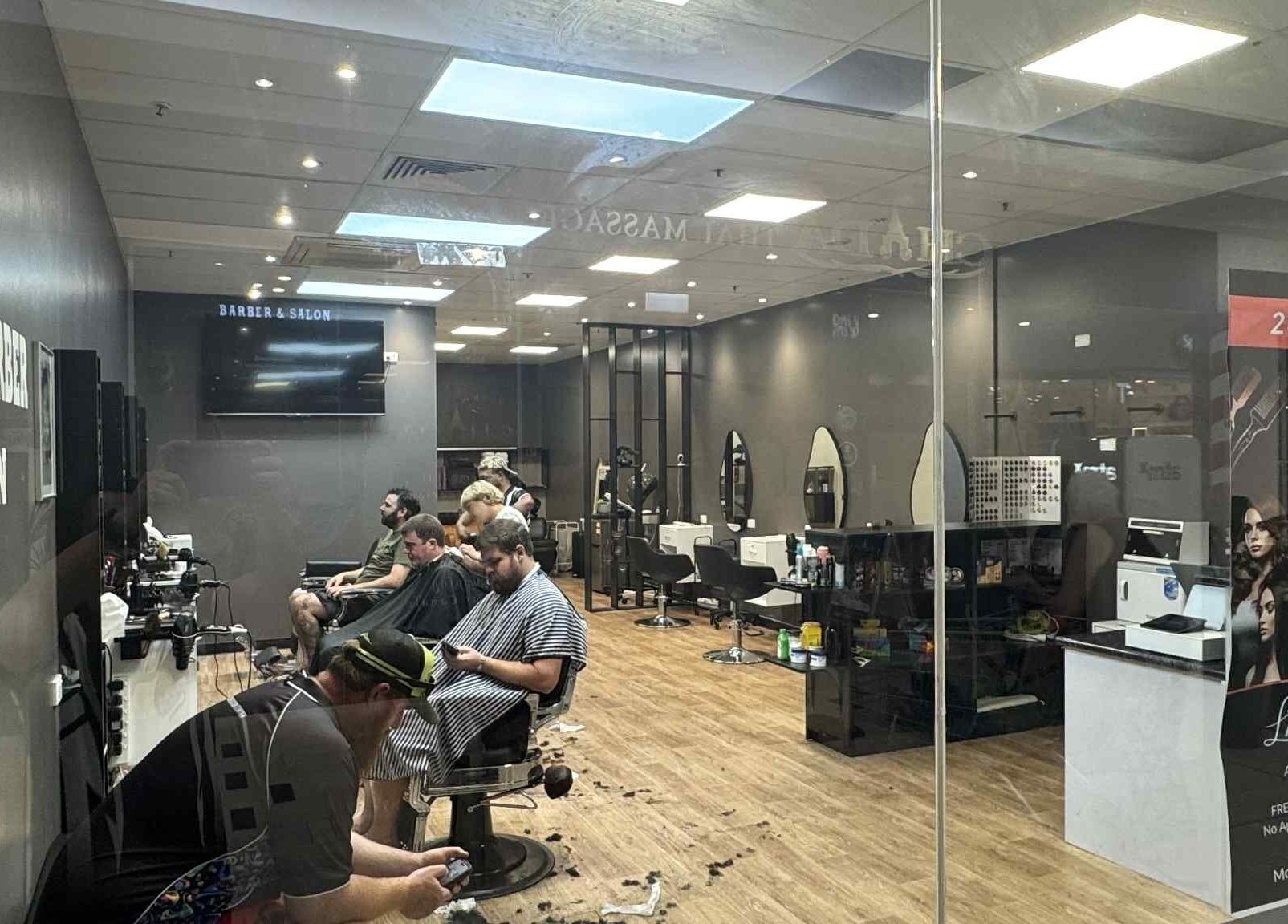 Interior of Captain Barber Oasis in Palmerston City, Northern Territory, AU showcasing modern salon layout.