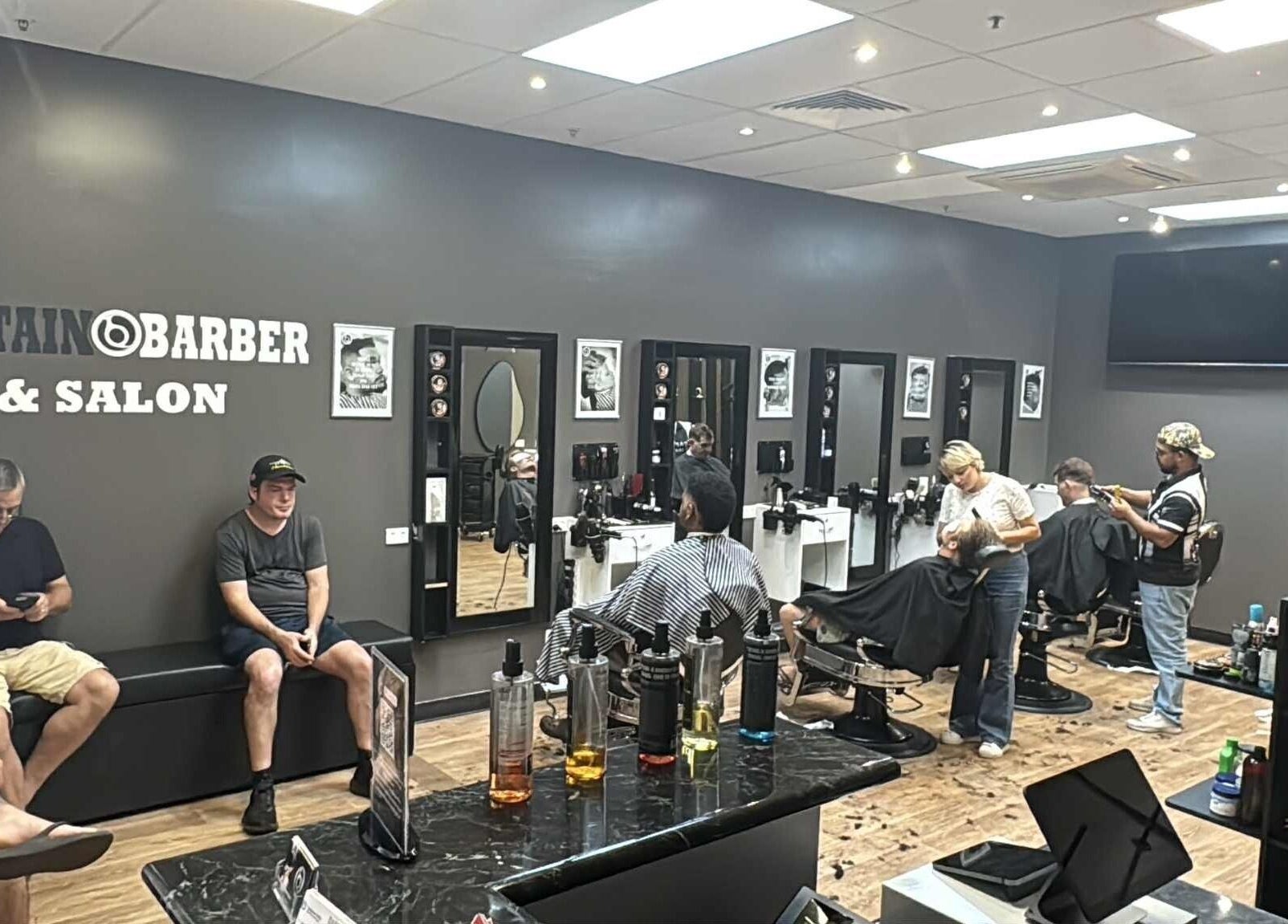 Inside Captain Barber Oasis at Palmerston City, NT, AU, showcasing stylish haircuts and modern interior.
