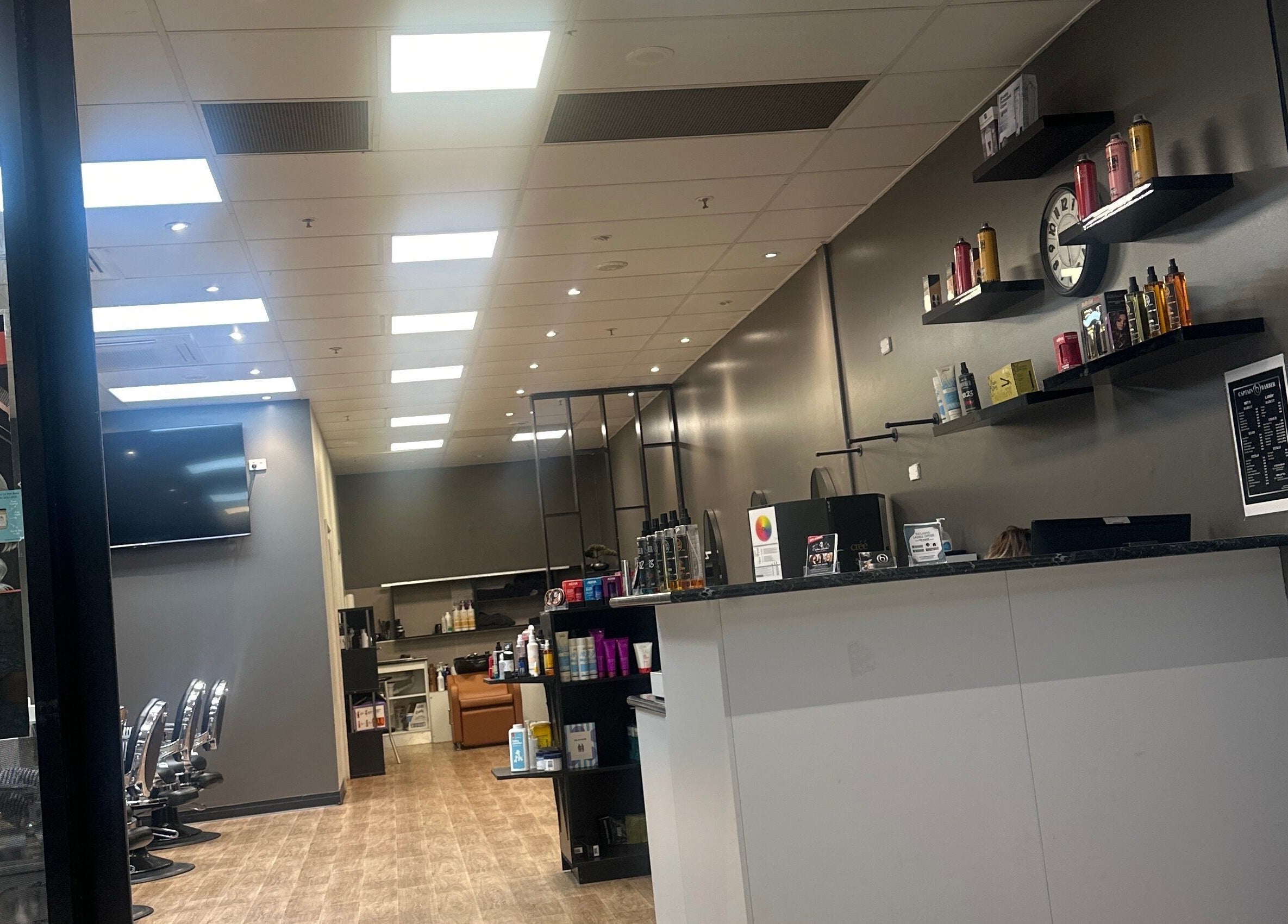 Modern interior of Captain Barber Oasis, Palmerston City, Northern Territory, AU, featuring sleek shelves and chairs.