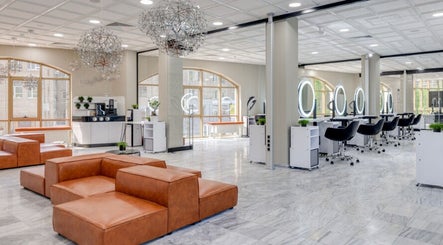 Sleek interior of Jio Hair Care in Ahmedabad, Gujarat, IN with modern seating and styling stations.