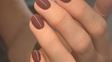 Elegant brown nails with a sleek stripe design at Studio Cassia 21, Mansfield, England, GB.
