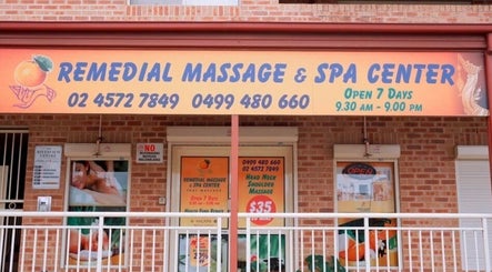 Entrance of Remedial Massage & Spa Centre, North Richmond, New South Wales, AU with vibrant sign and glass doors.