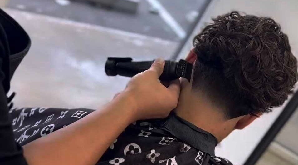 Close-up haircut with clippers at Backyard Barbers Darwin, Millner, Northern Territory, AU.