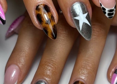 Stylish manicure at Nails By Ellise, Airdrie, Scotland, GB, featuring vibrant pattern designs.