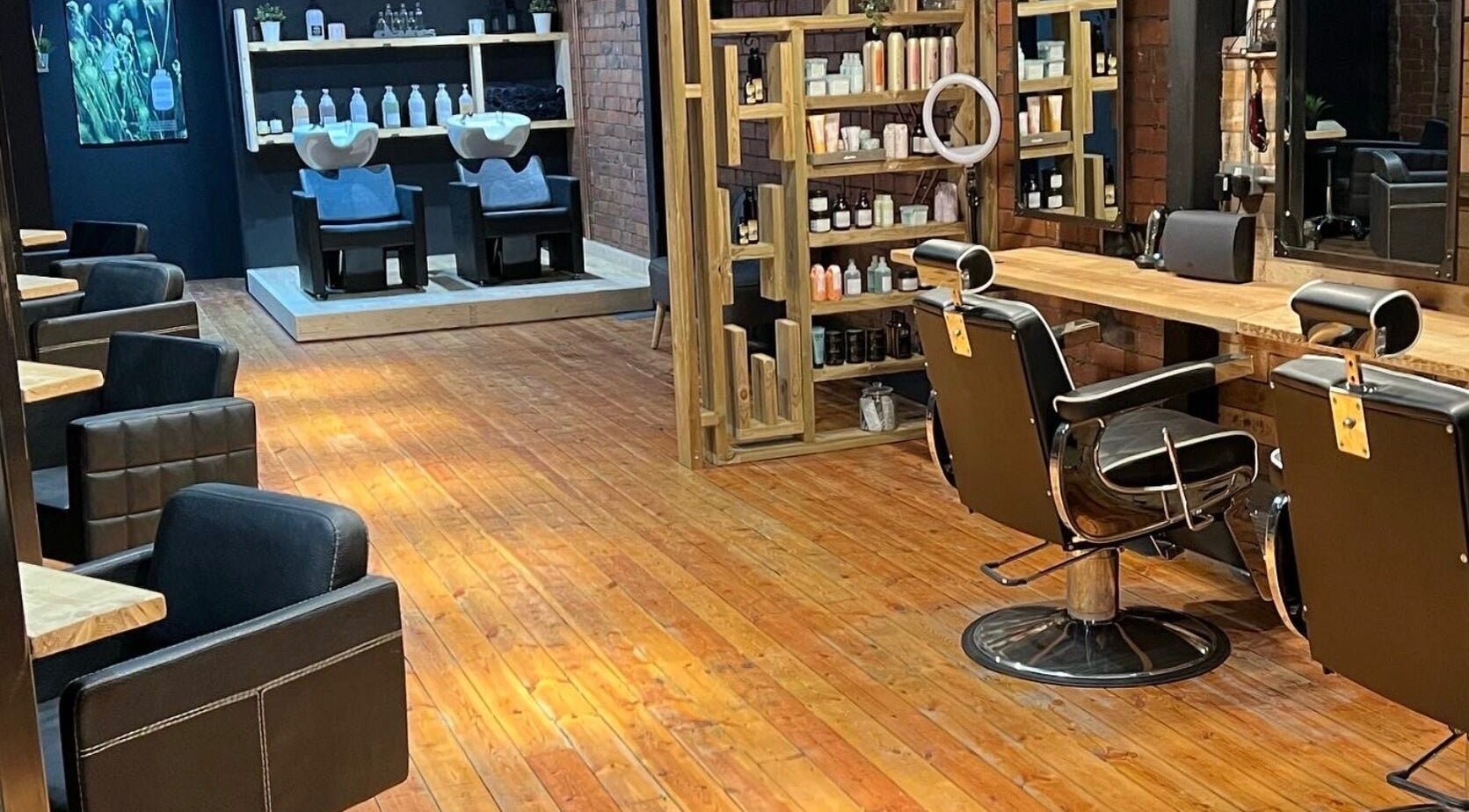 Inside Hidden Nail Works salon, Middlestown, England. Stylish chairs, wooden floors, modern decor.