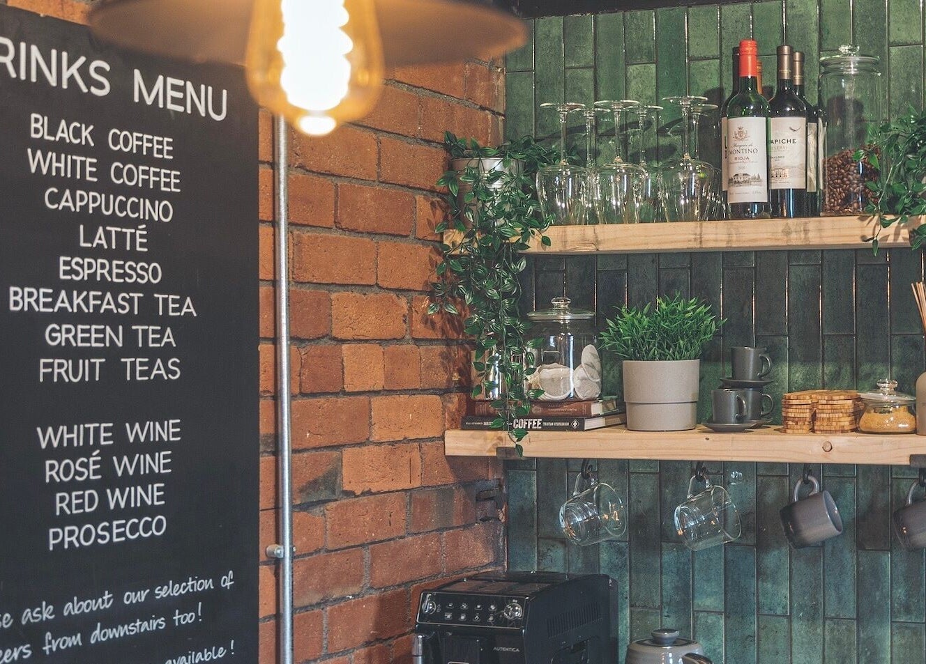 Charming beverage nook at Hidden Nail Works, Middlestown, England, featuring a menu and coffee setup.