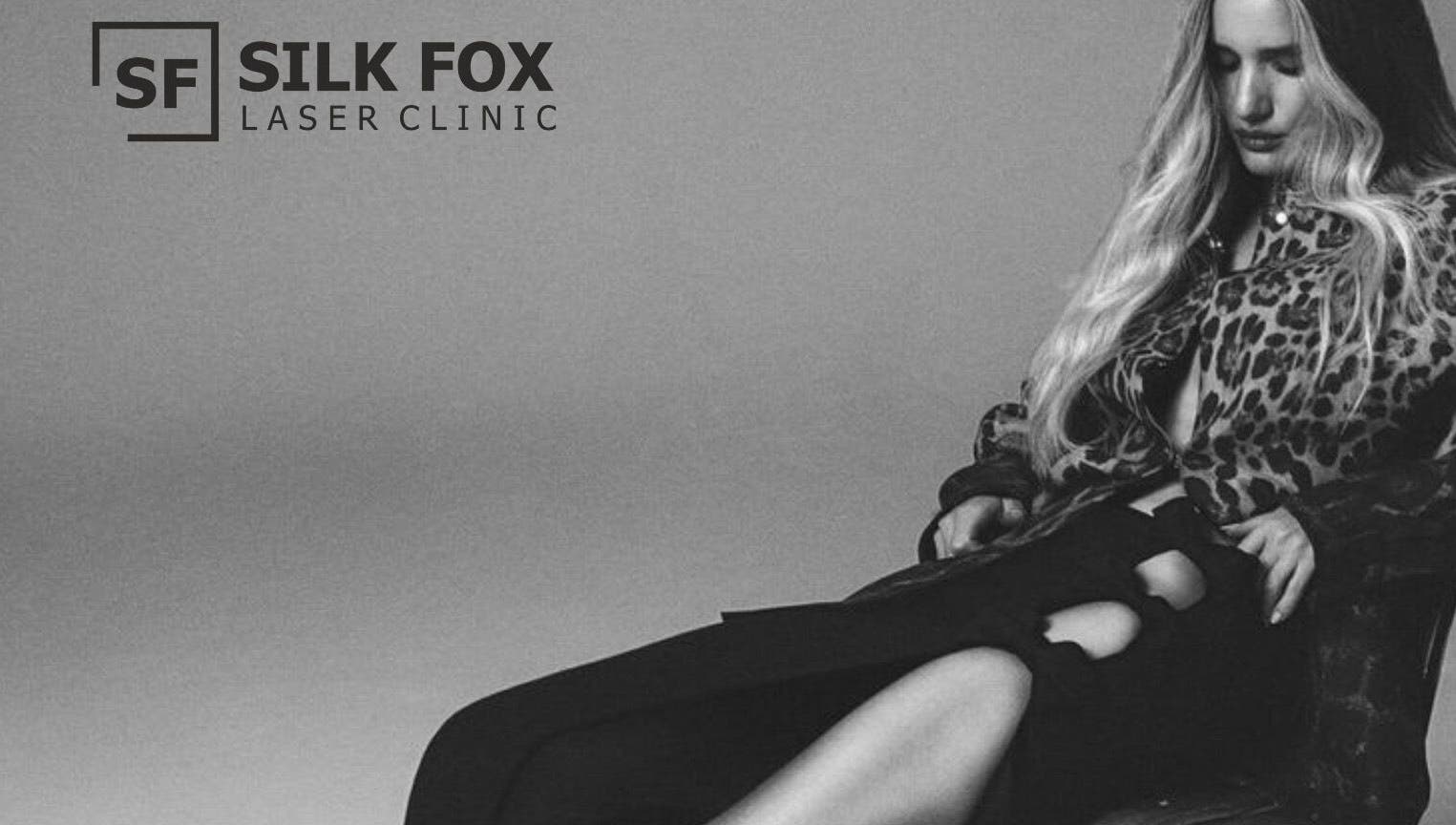 Elegant woman in stylish attire relaxing at Silk Fox PREMIUM laser clinic PLAZA, Rīga, LV.