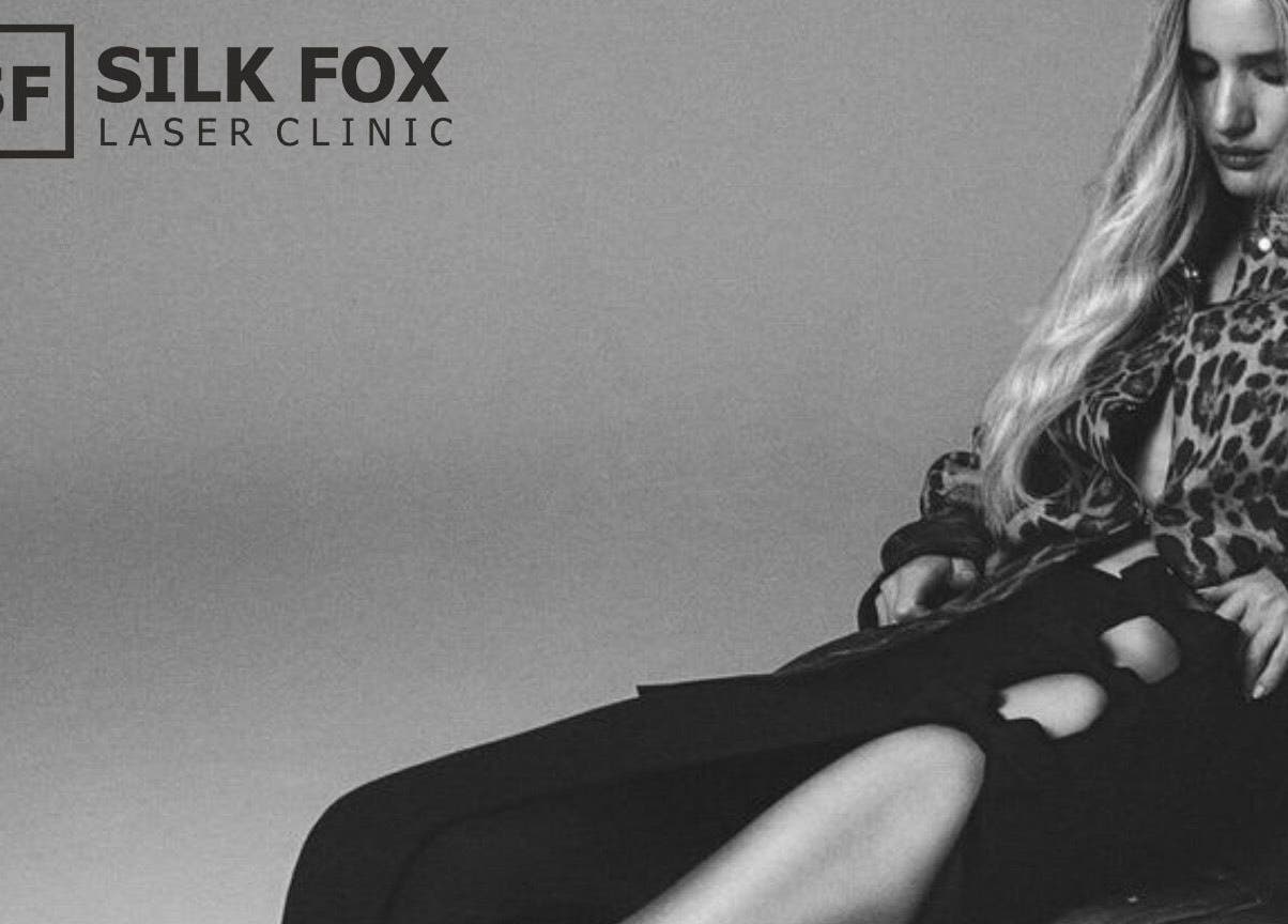 Elegant woman in stylish attire relaxing at Silk Fox PREMIUM laser clinic PLAZA, Rīga, LV.