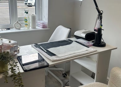 Modern nail station at Studio1_byJordan, Featherstone, England, GB. Sleek design with white chair and organized tools.