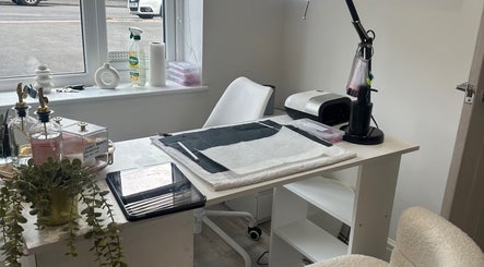 Modern nail station at Studio1_byJordan, Featherstone, England, GB. Sleek design with white chair and organized tools.