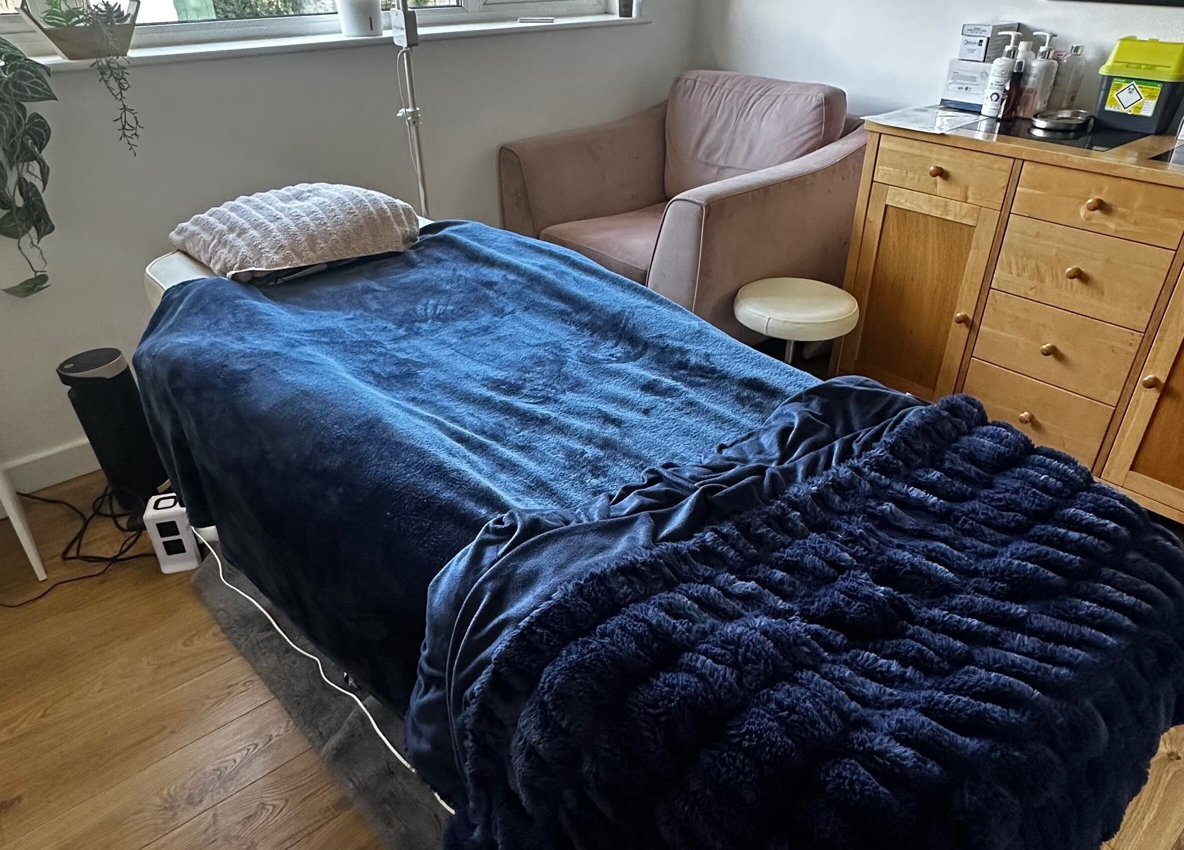 Cozy treatment room at Edge Nurse Aesthetics, East Harling, England, GB with plush bed and relaxing decor.