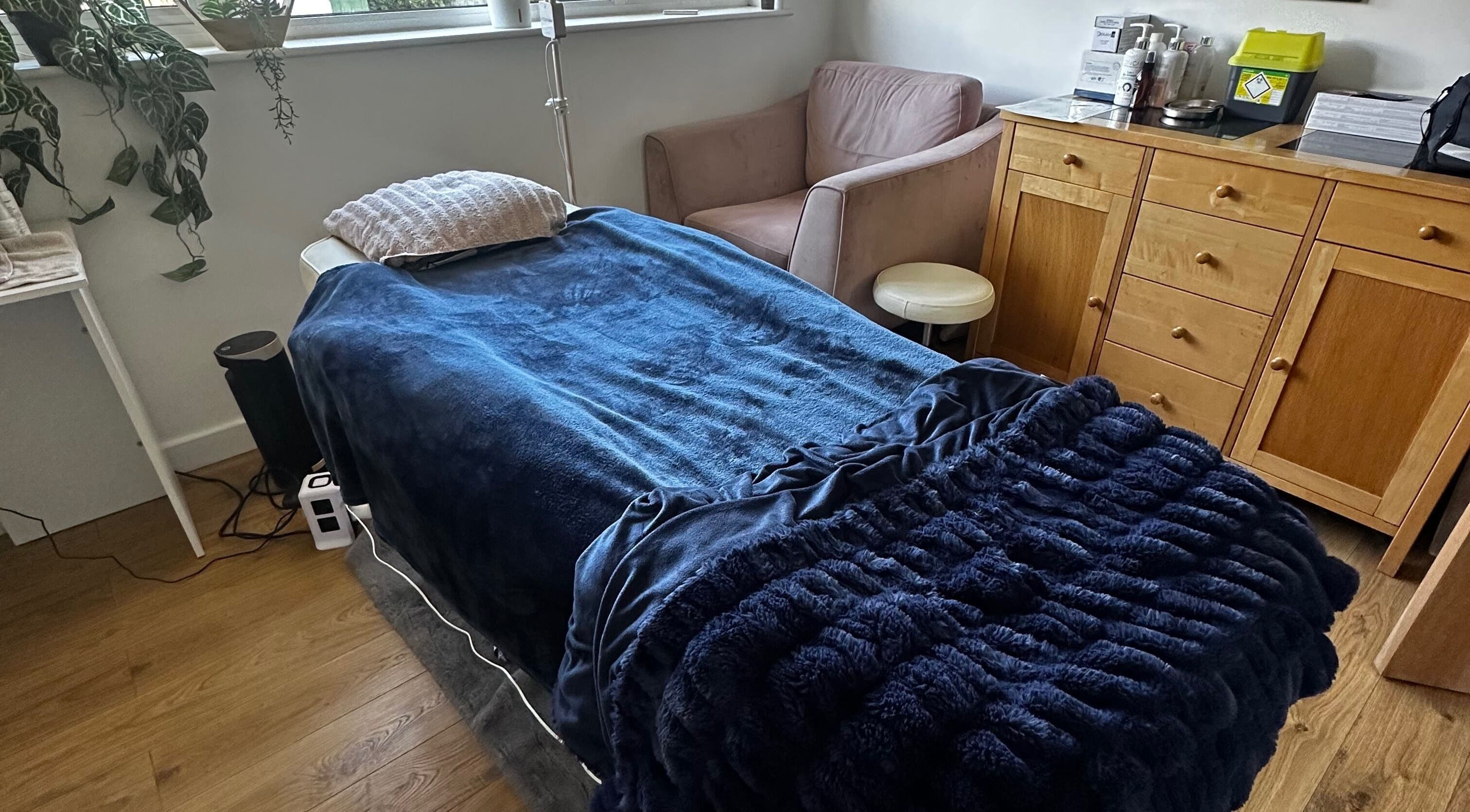 Cozy treatment room at Edge Nurse Aesthetics, East Harling, England, GB with plush bed and relaxing decor.