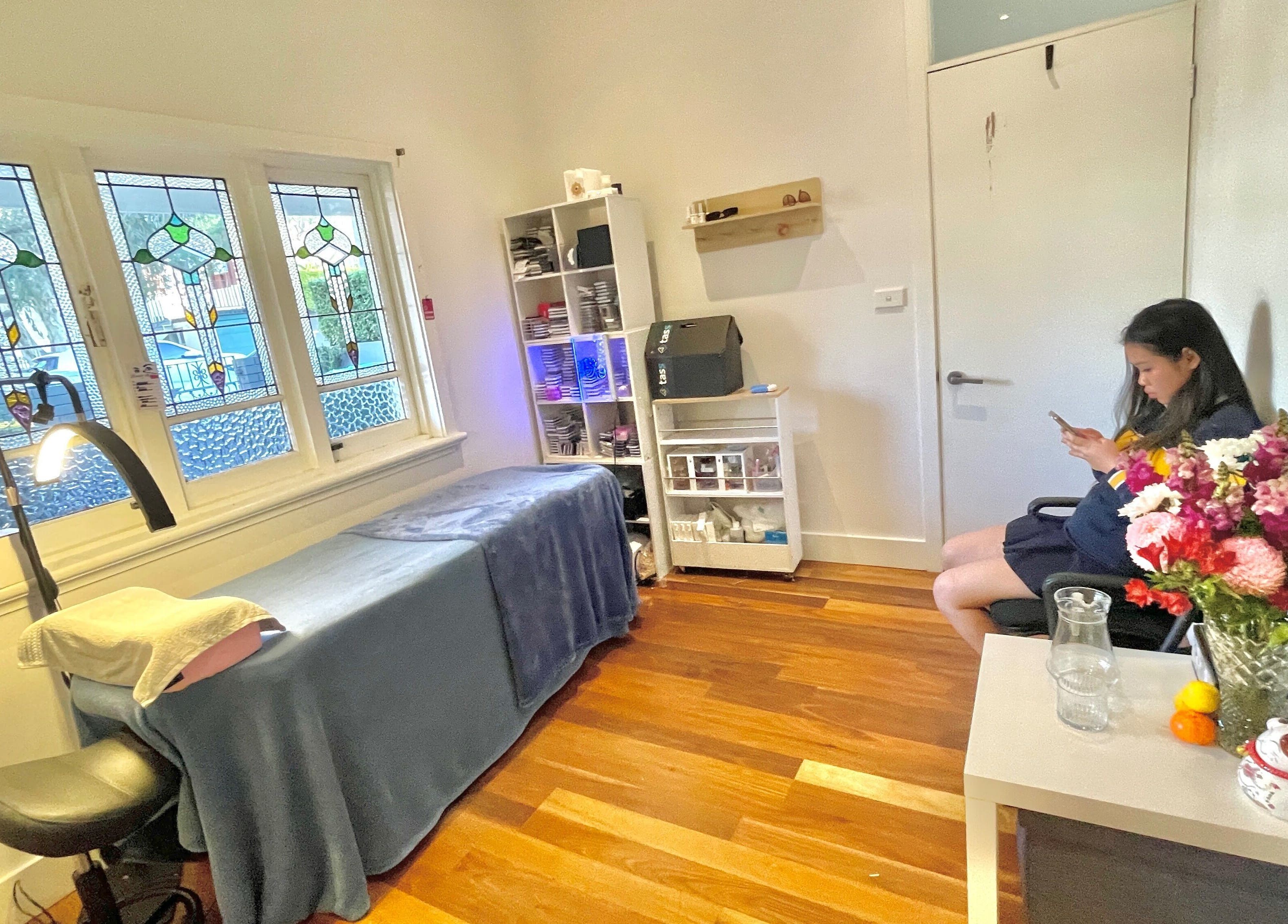 Relaxing treatment room at Honglylashes, Balmain, New South Wales, AU with stained glass windows.