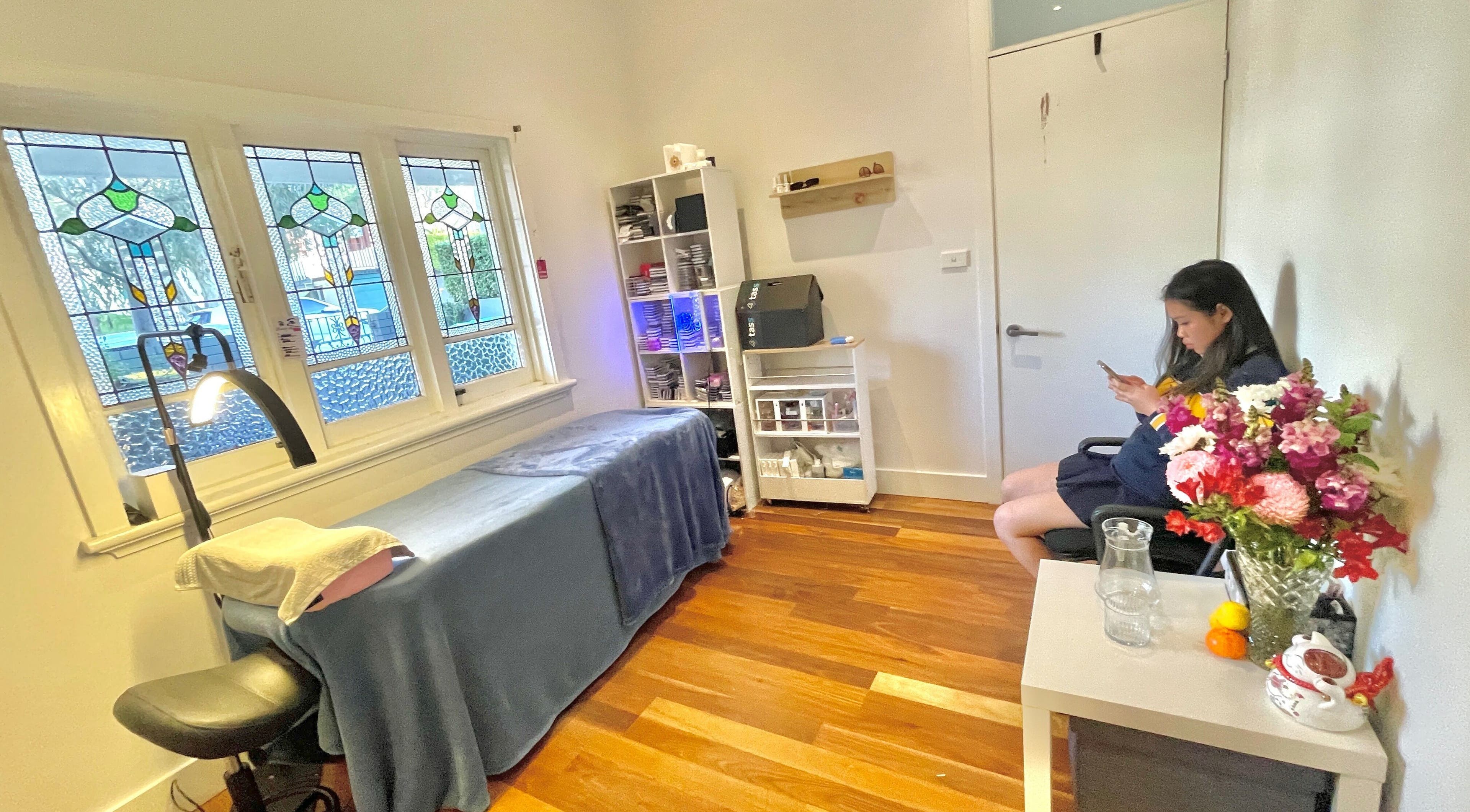 Relaxing treatment room at Honglylashes, Balmain, New South Wales, AU with stained glass windows.