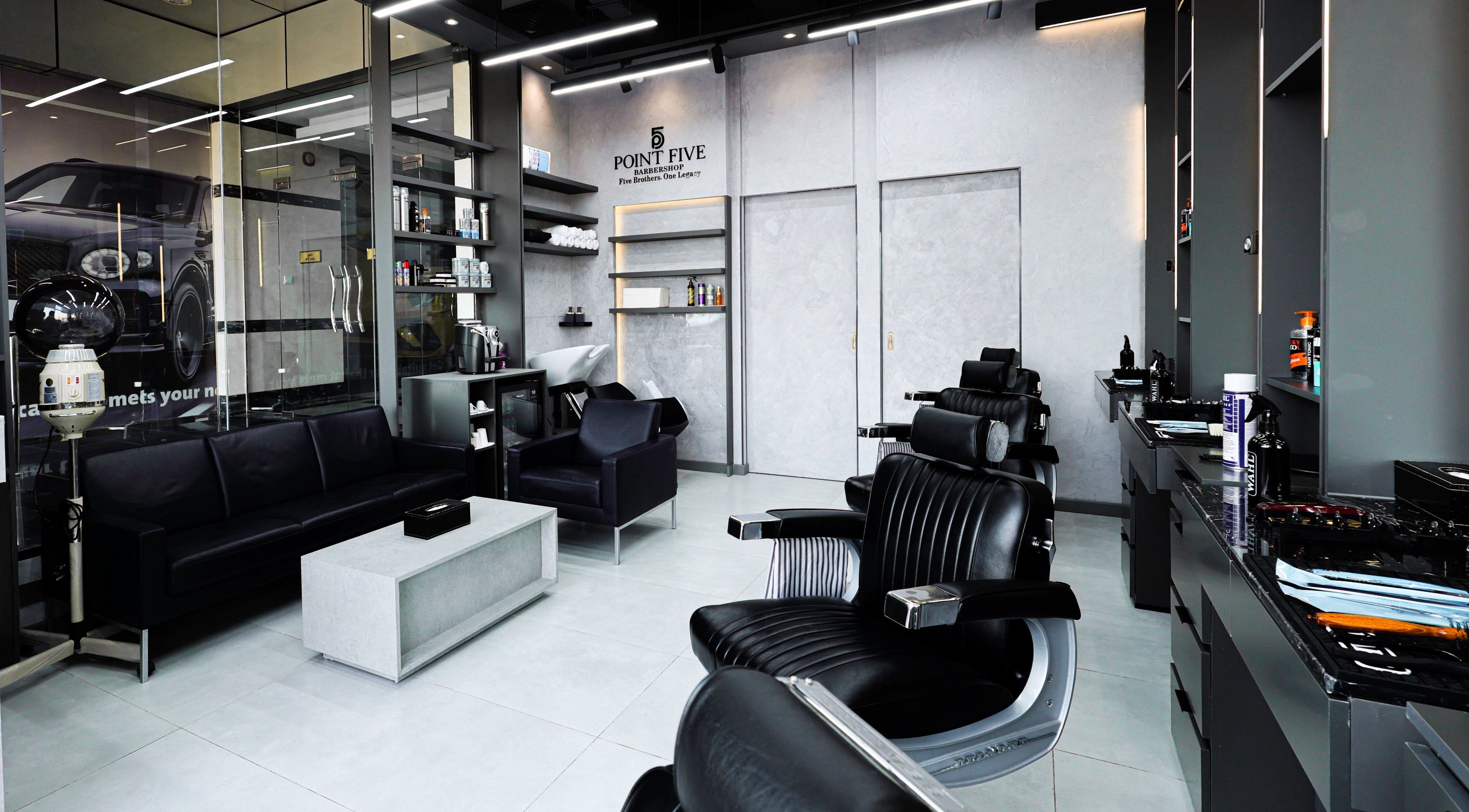 Modern interior of Point Five Barbershop in Dubai, AE, featuring sleek chairs and a luxurious ambiance.
