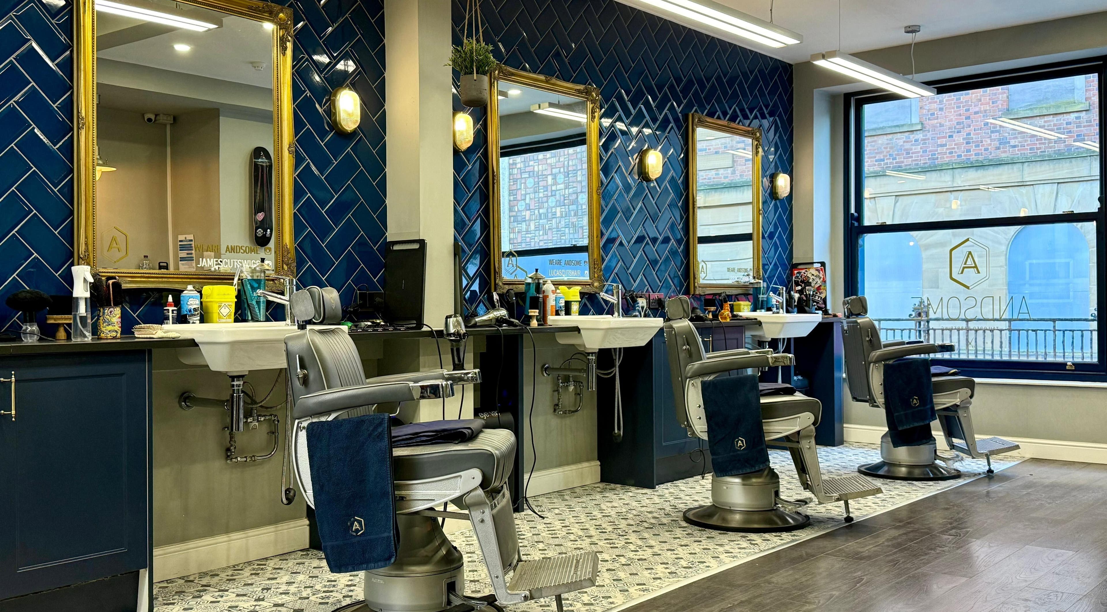 Modern interior of Andsome salon in Blackpool, England, featuring stylish barber chairs and elegant decor.