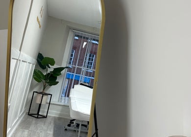 Modern treatment room at L.A Beauty & Aesthetics in Dereham, England, GB with stylish decor and large mirror.