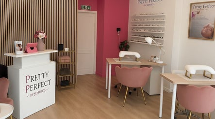 Chic interior of Pretty Perfect By Sophies in Bexleyheath, England, showcasing modern salon tables and decor.