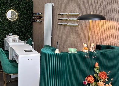 Stylish AK LUNĖ nail salon interior with green chairs and vibrant walls in Aberdeen, Scotland, GB.
