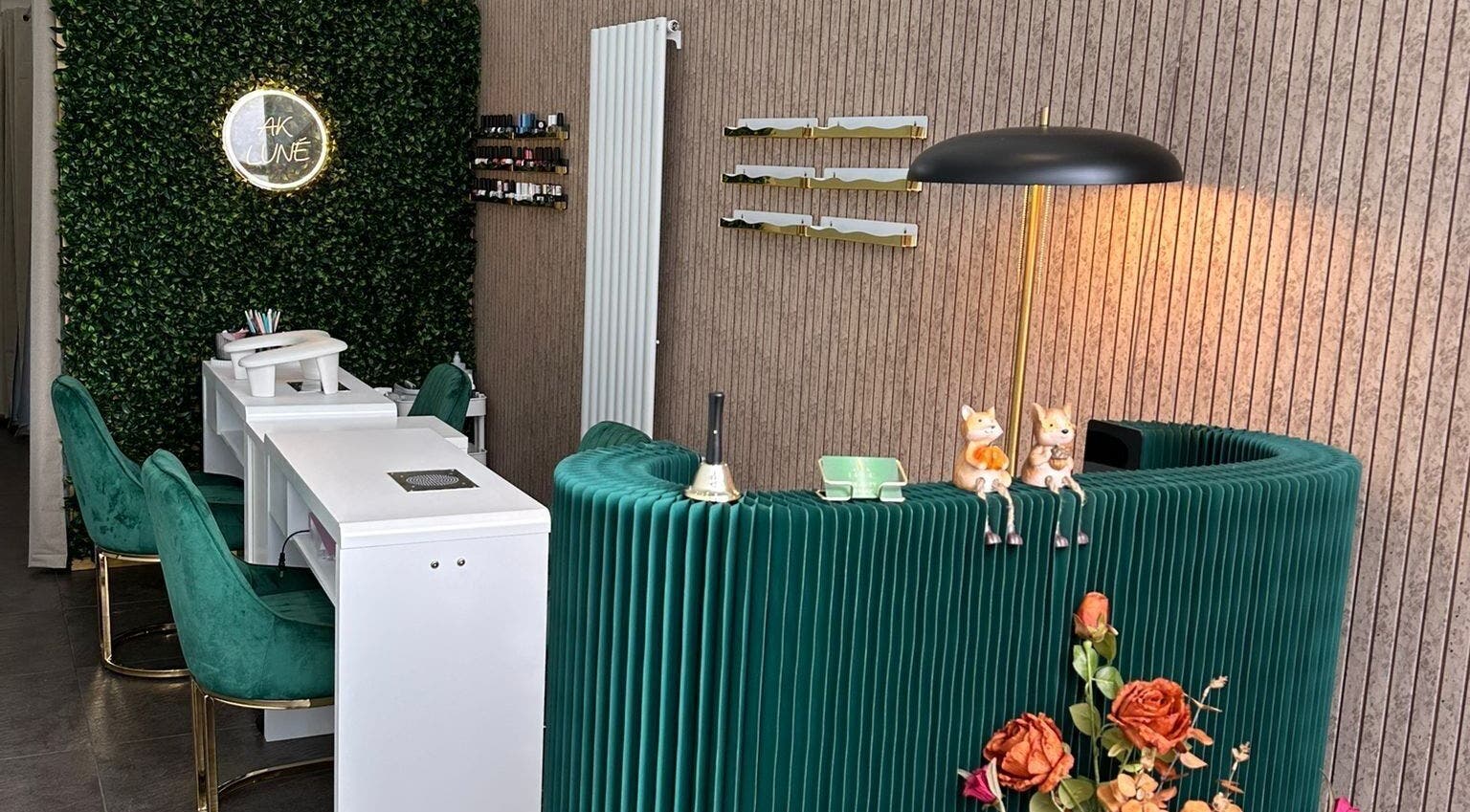 Stylish AK LUNĖ nail salon interior with green chairs and vibrant walls in Aberdeen, Scotland, GB.