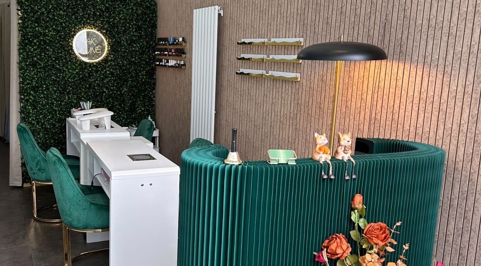 Stylish AK LUNĖ nail salon interior with green chairs and vibrant walls in Aberdeen, Scotland, GB.