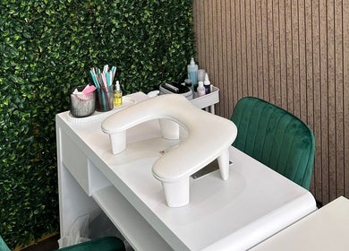 Chic nail station at AK LUNĖ, Aberdeen, Scotland, GB, featuring green chairs and foliage wall.