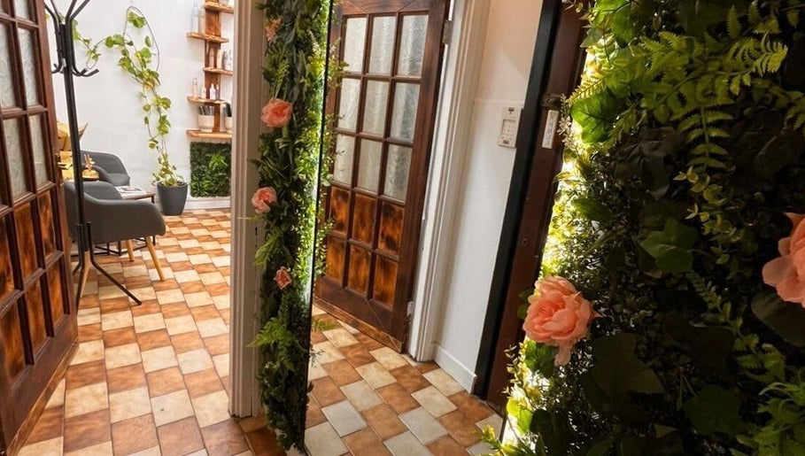 Entrance to Sanela haircraft, Drogheda, County Louth, IE, with vibrant floral decor and cozy seating.