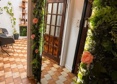 Entrance to Sanela haircraft, Drogheda, County Louth, IE, with vibrant floral decor and cozy seating.