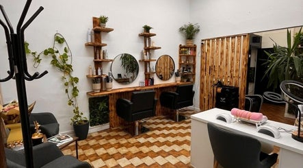 Stylish salon setup at Sanela haircraft, Drogheda, County Louth, IE, featuring sleek chairs and plant decor.