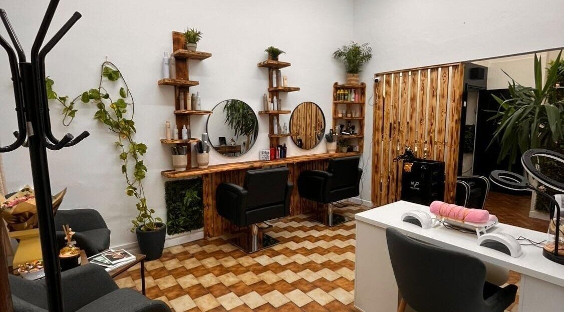 Interior of Sanela haircraft, Drogheda, County Louth, IE, featuring stylish chairs and rustic decor.