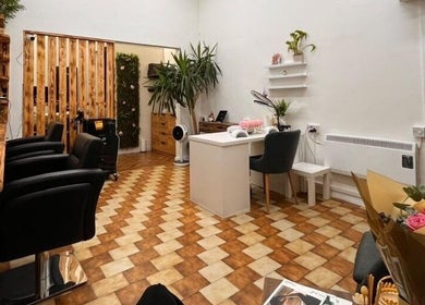 Stylish interior of Sanela haircraft, Drogheda, County Louth, IE, featuring salon chairs and a cozy seating area.