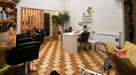Stylish interior of Sanela haircraft, Drogheda, County Louth, IE, featuring salon chairs and a cozy seating area.