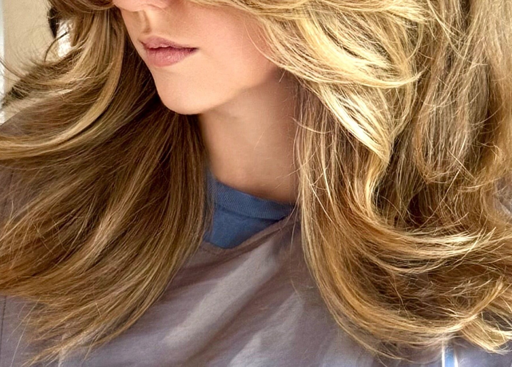 Flowing blonde hair styled at Sabrina Saeed Hairdesigner, Shelfords, England, GB.