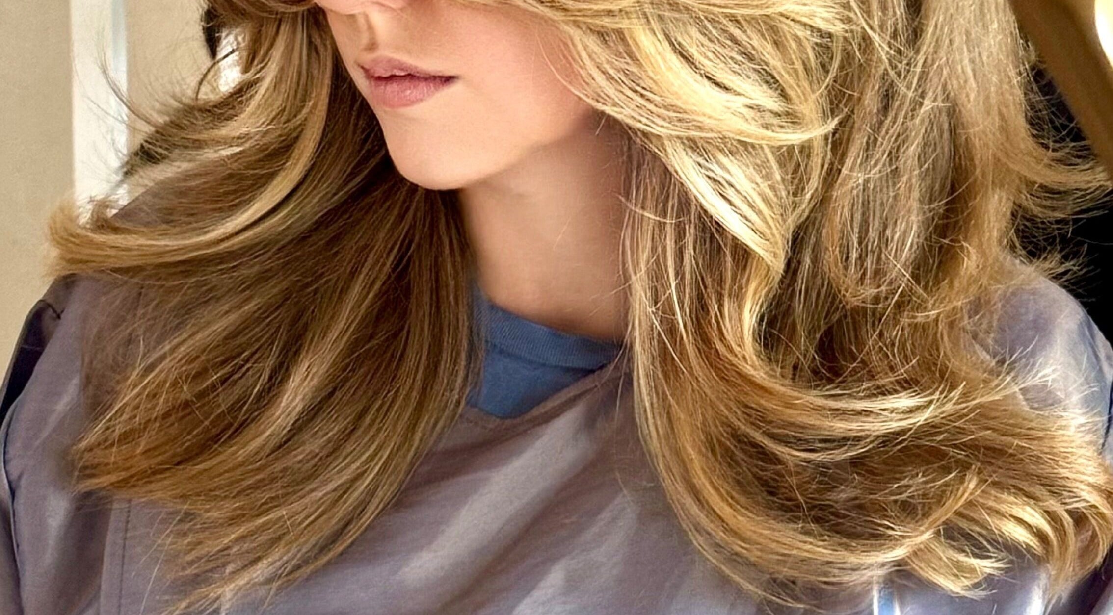 Flowing blonde hair styled at Sabrina Saeed Hairdesigner, Shelfords, England, GB.