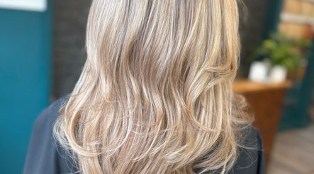 Blonde hair with subtle layers and soft curls at Haute Hair, Cheadle Hulme, England, GB.