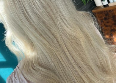 Sleek blonde hair styled at Haute Hair, Cheadle Hulme, England, GB. Perfect for a glamorous look.