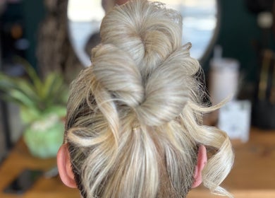 Elegant updo hairstyle at Haute Hair in Cheadle Hulme, England, GB. Showcases intricate styling.