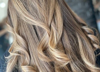 Elegant blonde waves hairstyle at Haute Hair in Cheadle Hulme, England, GB. Perfect for a stylish new look.