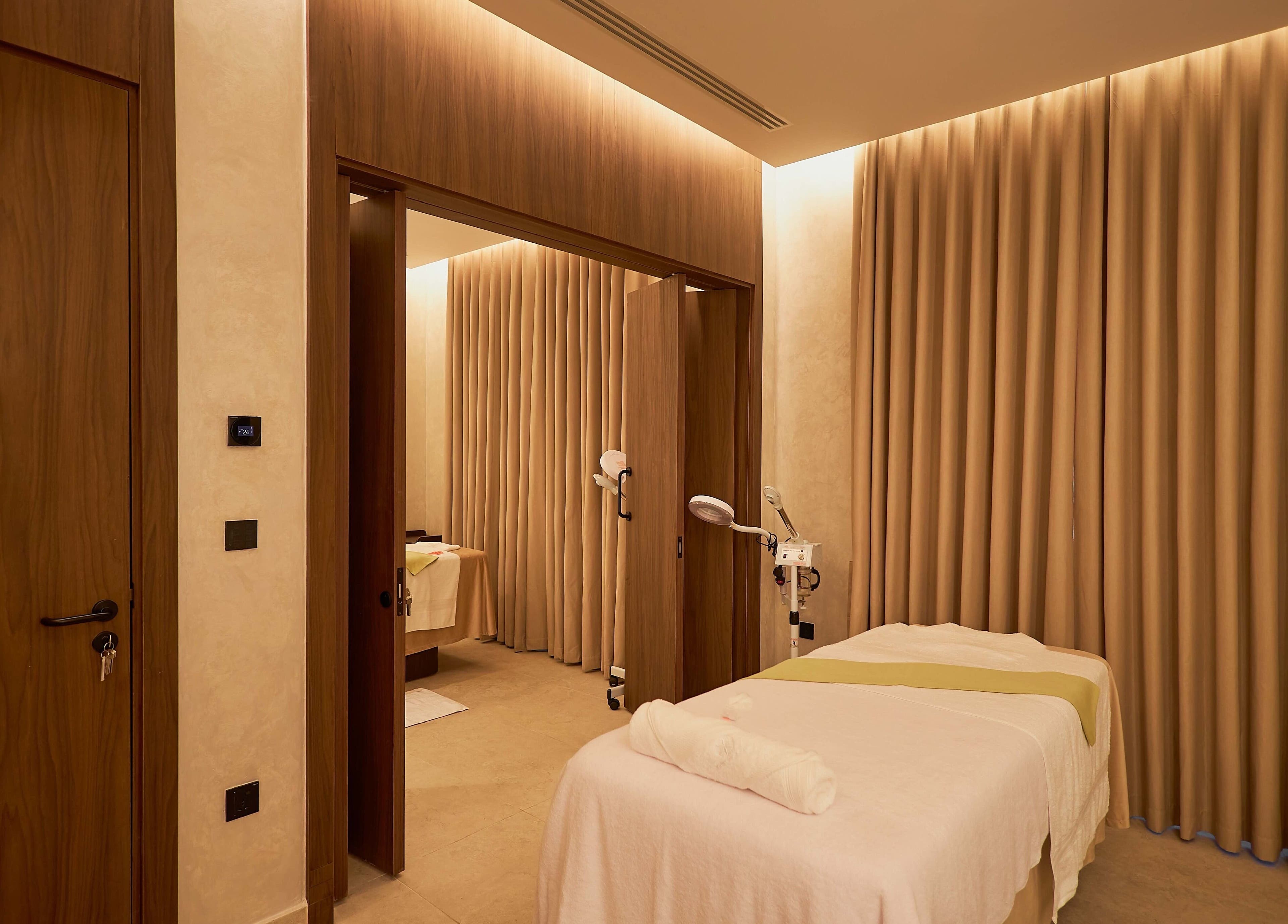 Tranquil treatment room at The Wheatbaker Spa, Lagos, Lagos, NG, with cozy lighting and comfortable massage table.