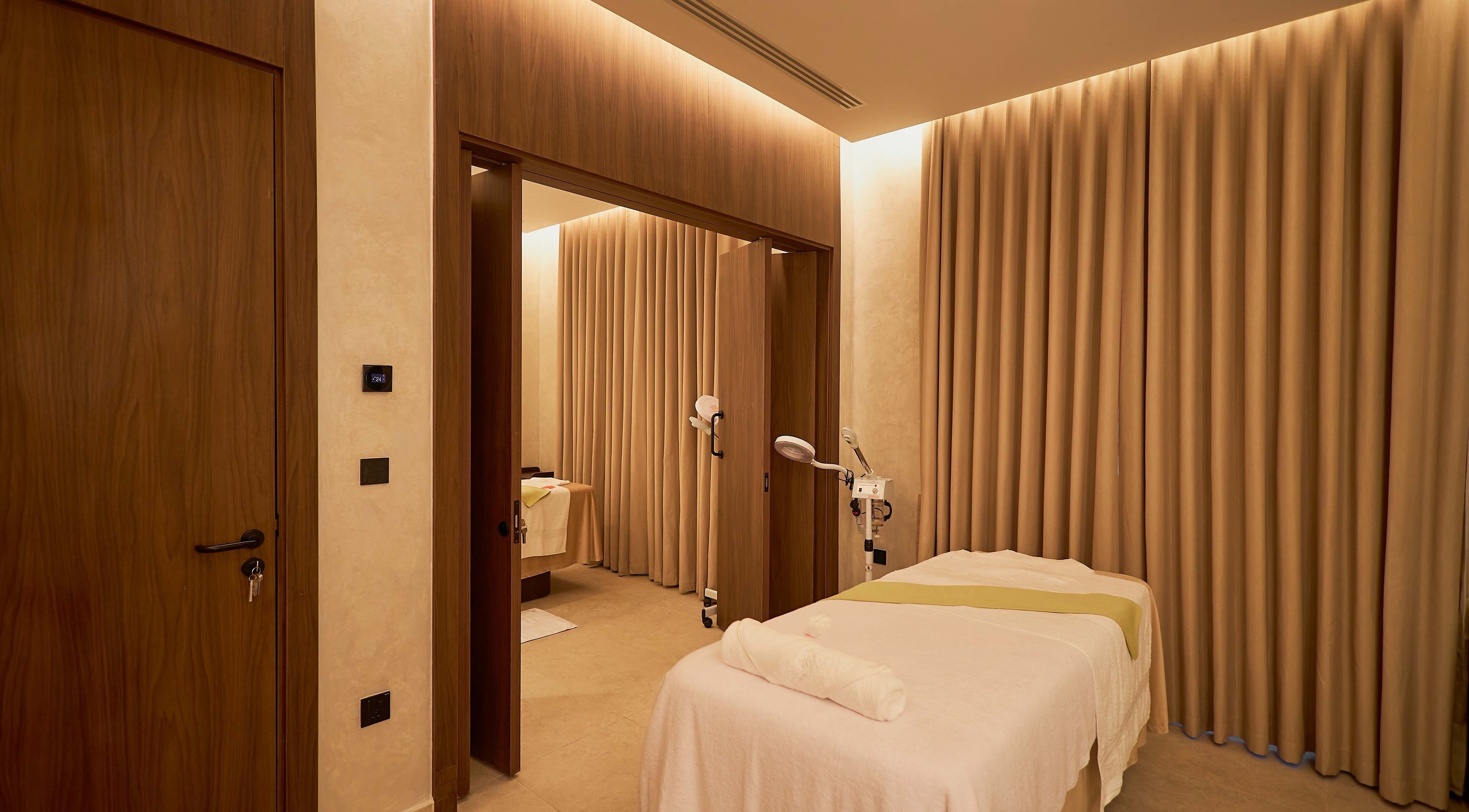 Tranquil treatment room at The Wheatbaker Spa, Lagos, Lagos, NG, with cozy lighting and comfortable massage table.