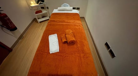 Relaxing massage room at Valique Retreat in Watford, England, GB, featuring a comforting orange towel setting.